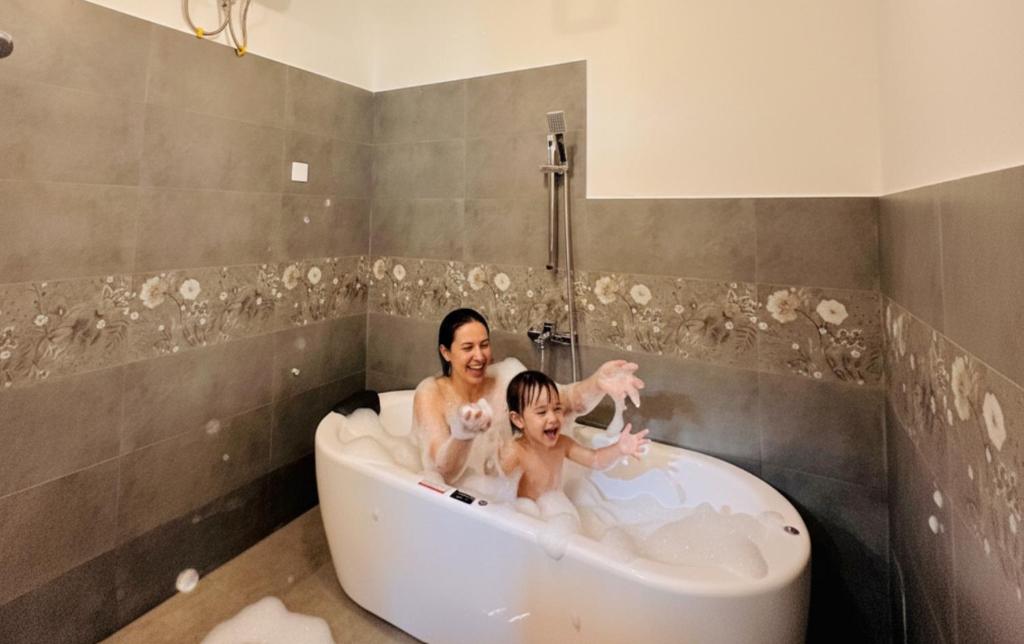 a woman and a child in a bath tub at The Ridge Colonial Villa in Ahangama