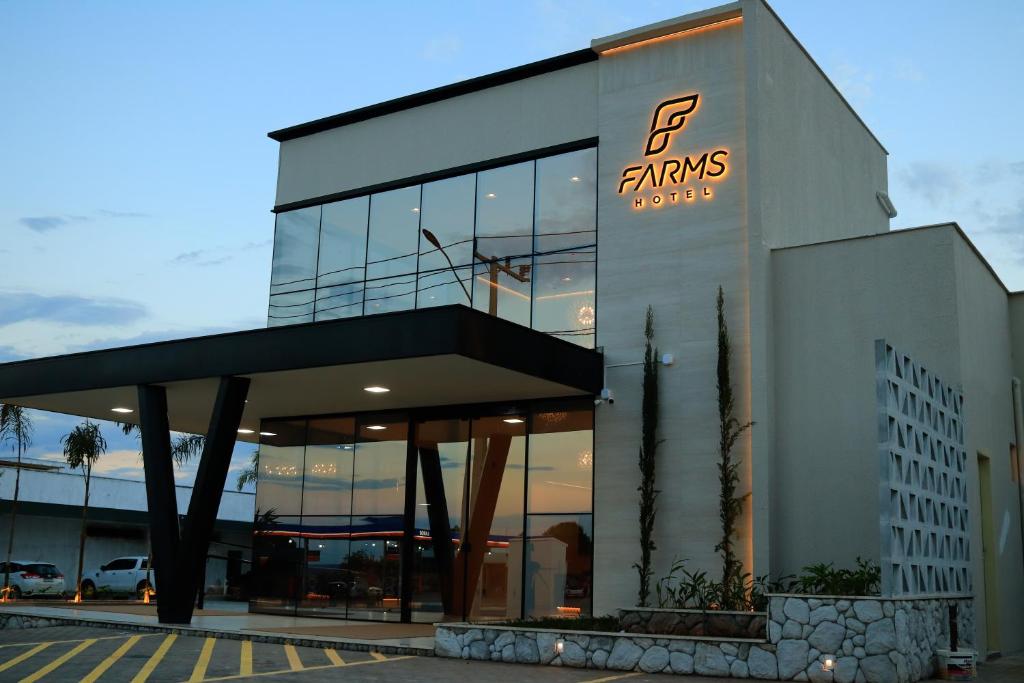 a building with a sign on the front of it at Farms Hotel in Coribe