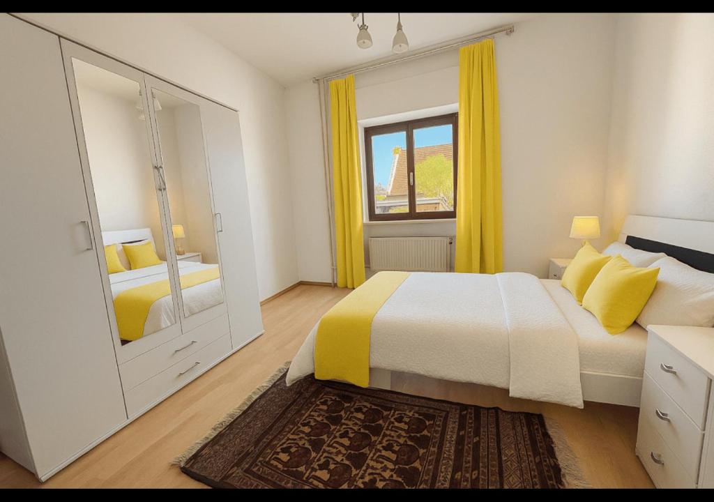 a bedroom with a bed and a window with yellow curtains at Flexibles Apartment nahe Frankfurt am Main in Niederdorla