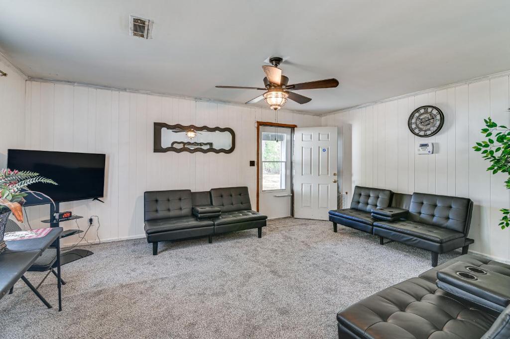 a living room with couches and a flat screen tv at Pet-Friendly Eutaw Home Near Historic Square in Eutaw