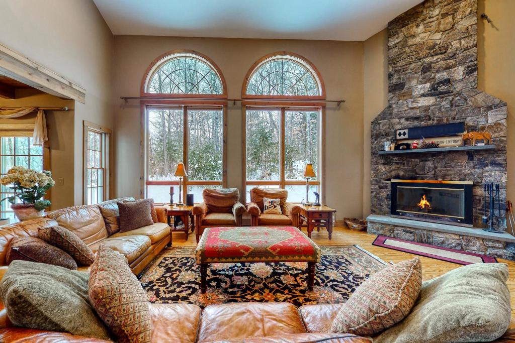 a living room with a couch and a fireplace at Moose Lodge Unit A in Newry