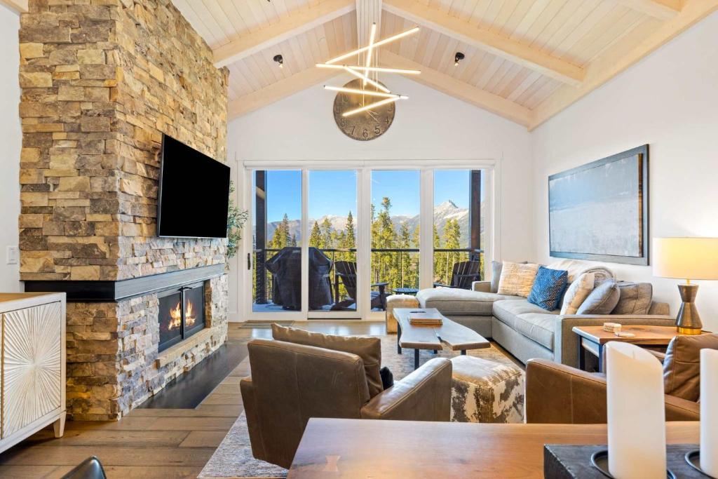 a living room with a couch and a fireplace at Moonlight Basin Lookout Patio Views & Ski In Out in Big Sky Mountain Village