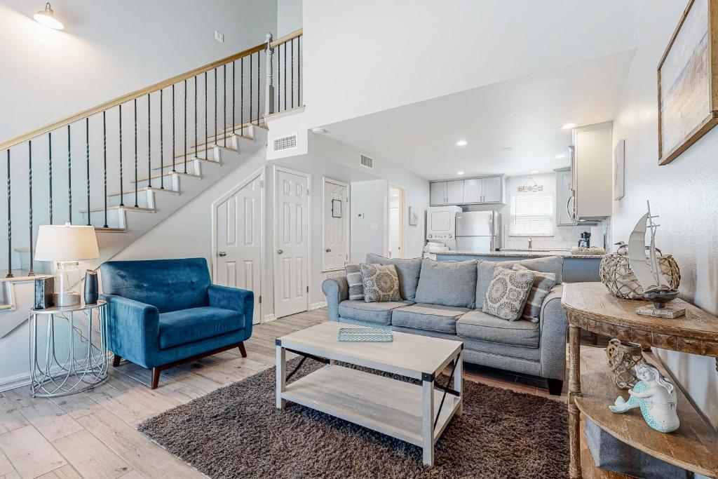 a living room with a couch and a table at Leeward Cove A8 in Padre Island