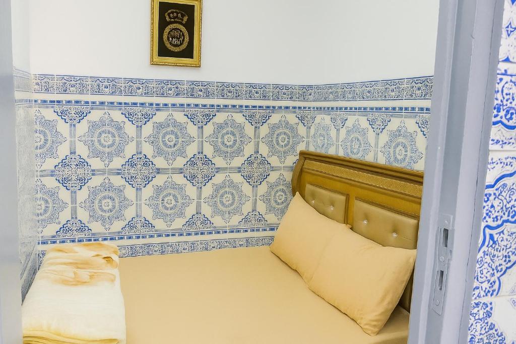 a small bedroom with blue and white tiles at DAR Souaad Bab Doukkala in Marrakech