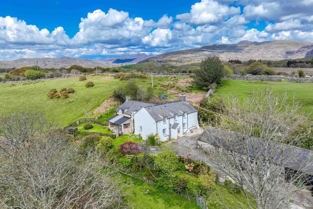 an aerial view of a white house in a field at Allt-Goch in Llanbedr