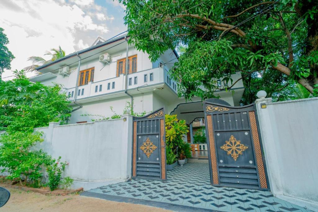 a house with a gate and a fence at Joy Villa Garden in Batticaloa
