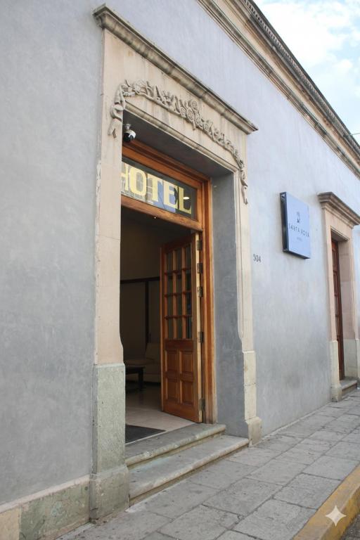 an entrance to a hotel with a wooden door at Hotel Santa Rosa in Oaxaca City