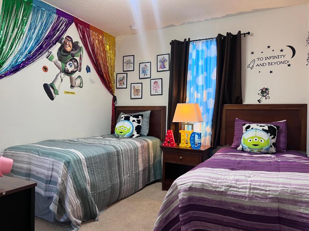 a bedroom with two beds with stuffed animals on them at Toy Story Getaway Retreat in Kissimmee