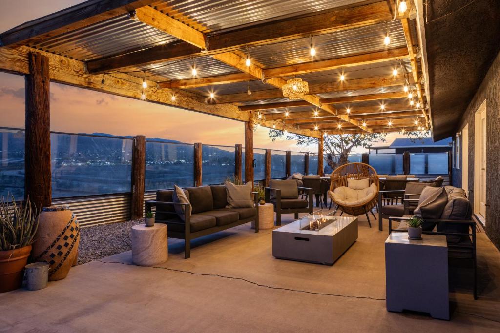 a patio with furniture and a view of the city at Desert Haven, Pickleball, Stargazing, Spa & Views in Joshua Tree