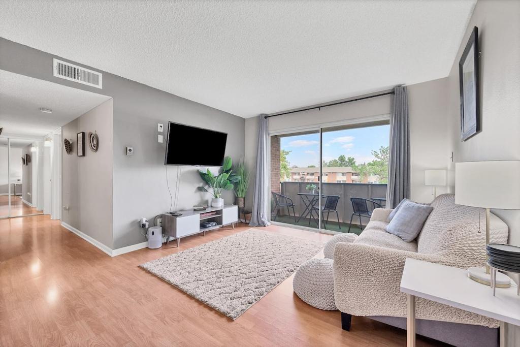 a living room with a couch and a tv at Boulder Basecamp - Cozy 2BR Near Trails & Town 