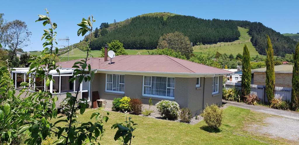 a house with a dog standing on the roof of it at Harmonious Social Retreat in Rotorua