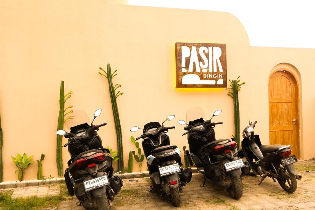 three motorcycles parked in front of a building at Pasir 1 - A stylish 2 bed duplex in Bingin w pool in Bingin Beach
