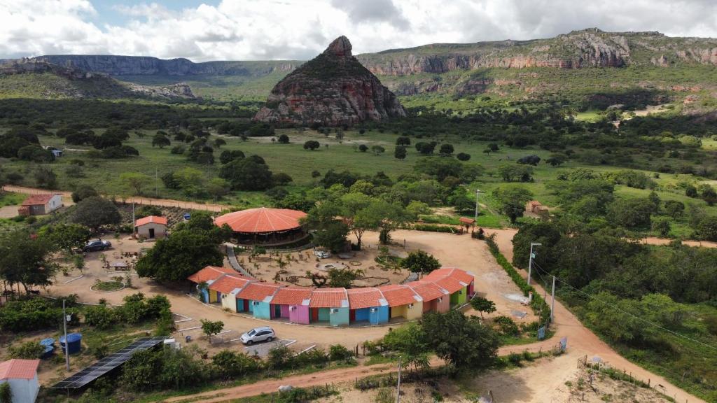 an aerial view of a camp with a mountain in the background at Pousada Vila Mara do Sertão in Buíque