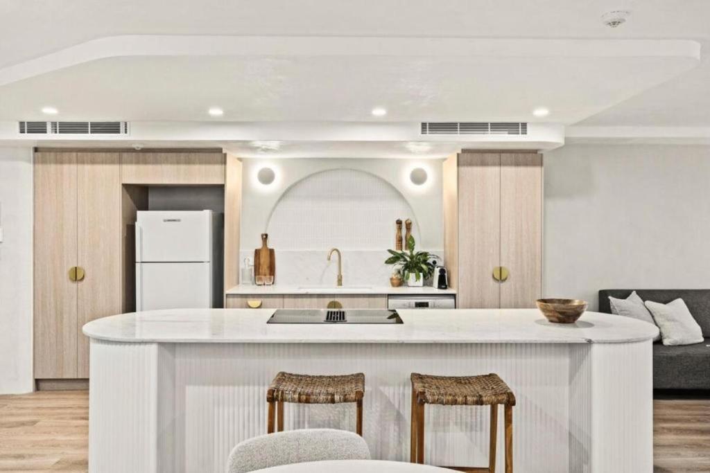 a kitchen with a large white island in a room at Luxury Living on Monaco Riverfront - Hosted by Coastal Letting Co. in Gold Coast