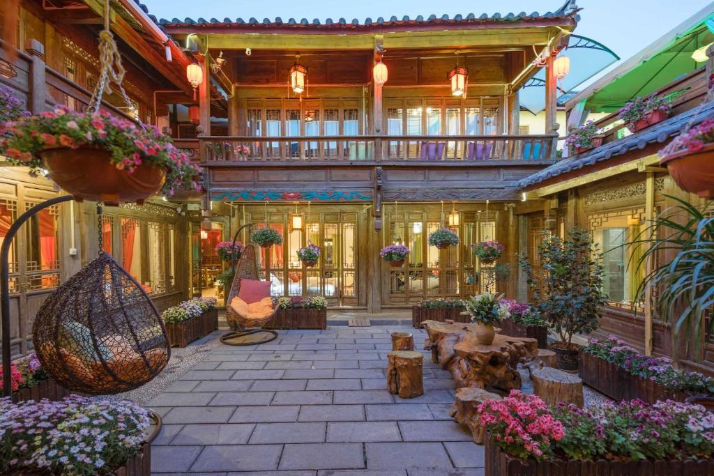 a courtyard of a building with flowers and plants at Flower without boundry in Lijiang