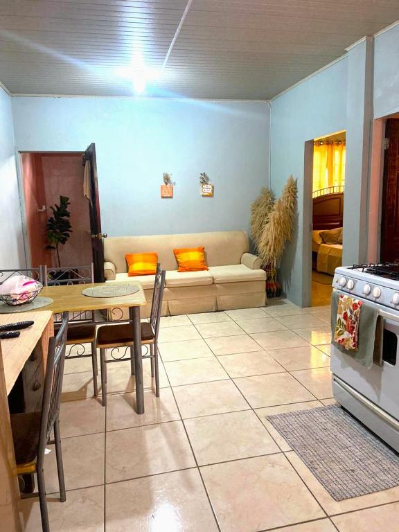 a living room with a table and a couch at Relaxing 2 bedroom with AC, WiFi, Central Location in Golconda