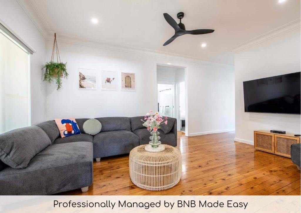 a living room with a couch and a tv at The Fitzhill - East Dubbo Close to CBD in Dubbo
