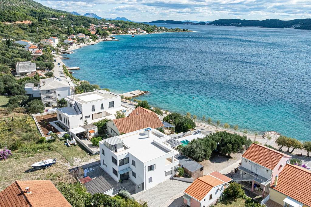 an aerial view of a village and the water at Apartments by the sea Viganj, Peljesac - 24663 in Orebić