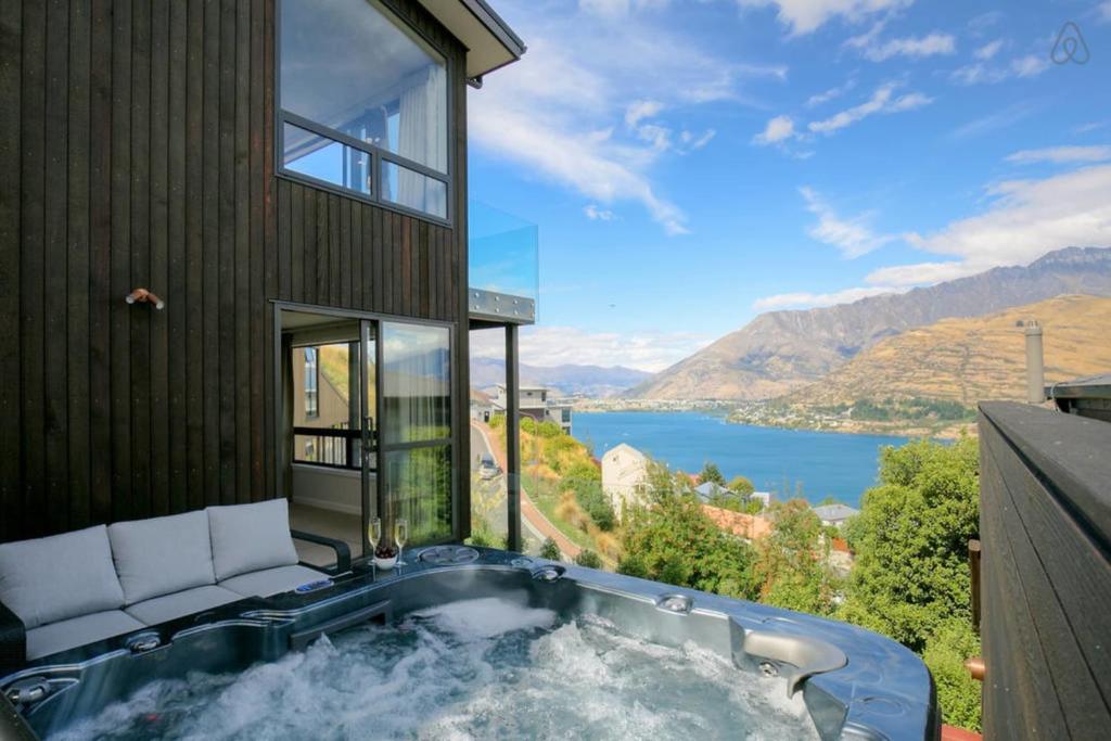 a hot tub in a house with a view of the water at Birch Haven Spa and Views in Queenstown