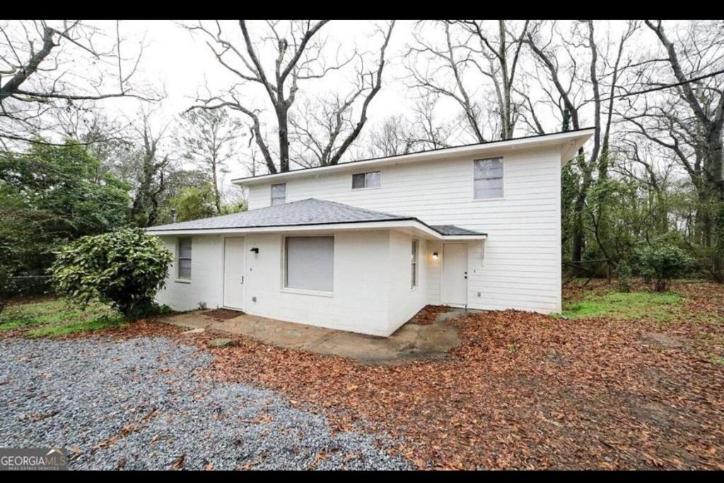 a white house sitting on top of a pile of leaves at Game Day Ready! 2 King Beds Near UGA & DT in Athens