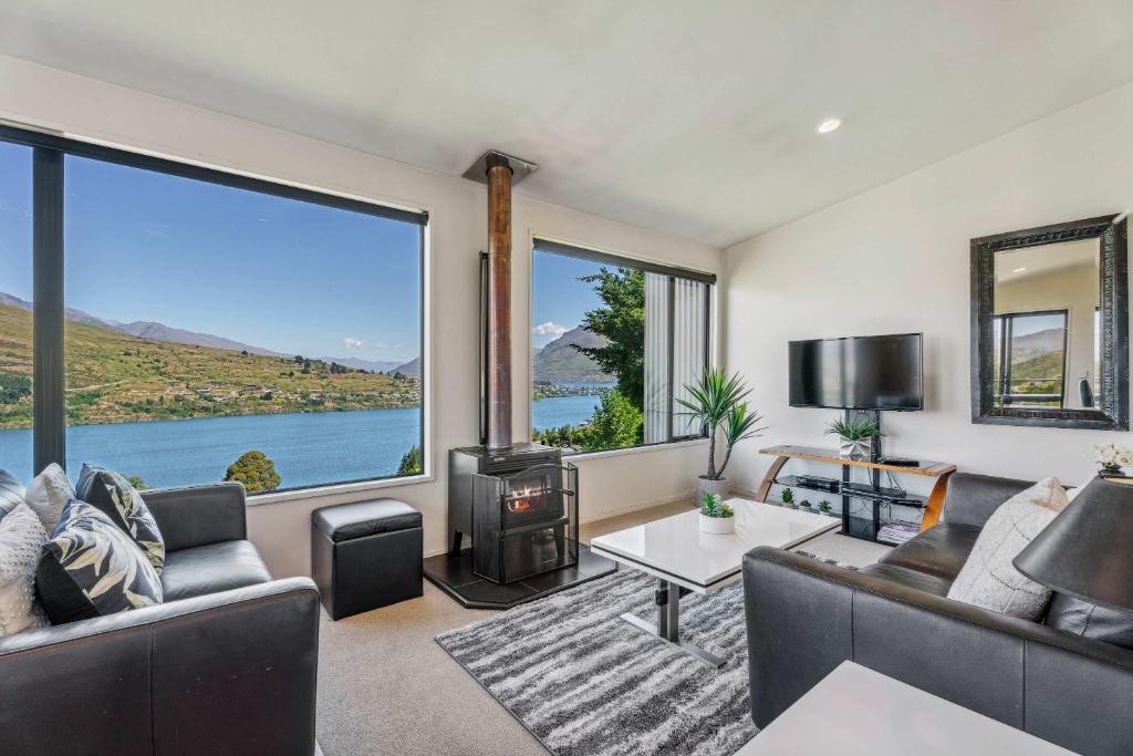 a living room with a view of the water at Magical views Perfect place to stay in Frankton Wharf
