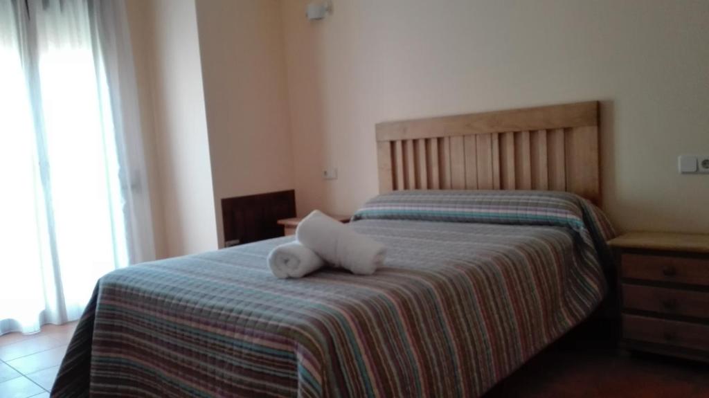 Postel nebo postele na pokoji v ubytování Hostal La Vega