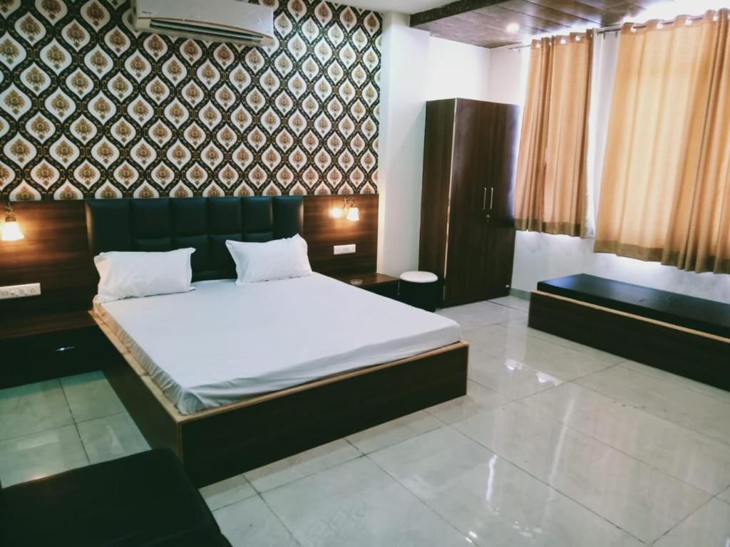 Ένα ή περισσότερα κρεβάτια σε δωμάτιο στο Hotel Nandini