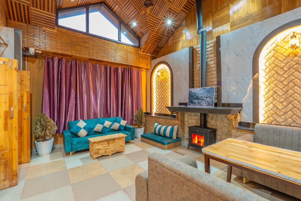 a living room with a couch and a fireplace at Monal Homestay in Kulu