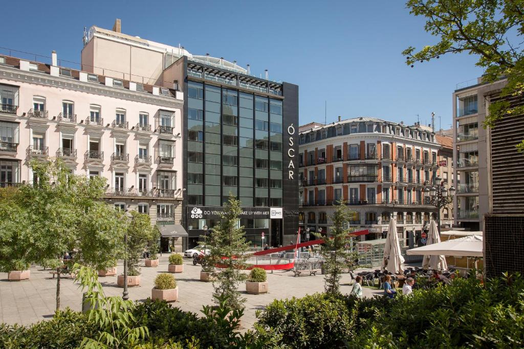 a city with buildings and a courtyard with trees at Room Mate Oscar, Madrid in Madrid