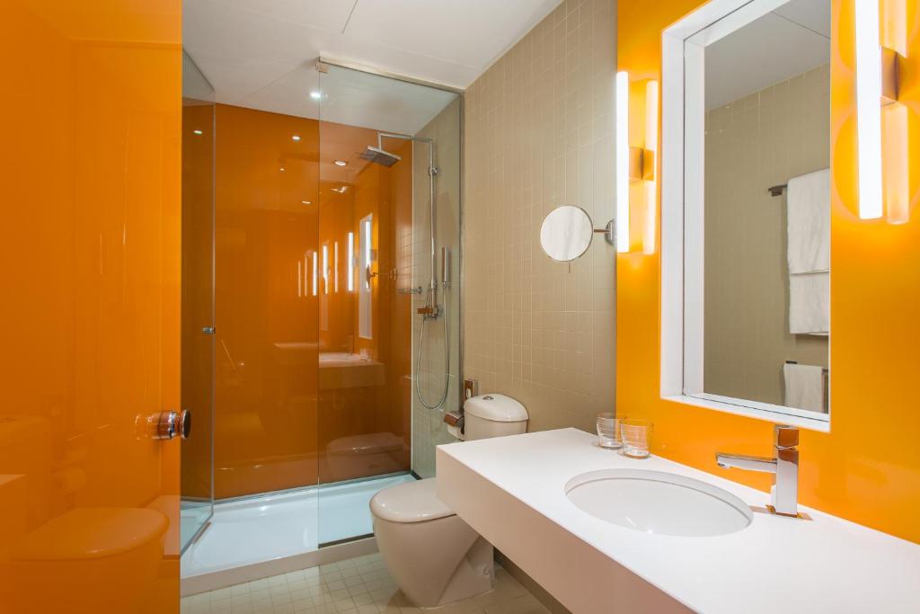 a bathroom with a toilet and a sink and a shower at Room Mate Oscar, Madrid in Madrid