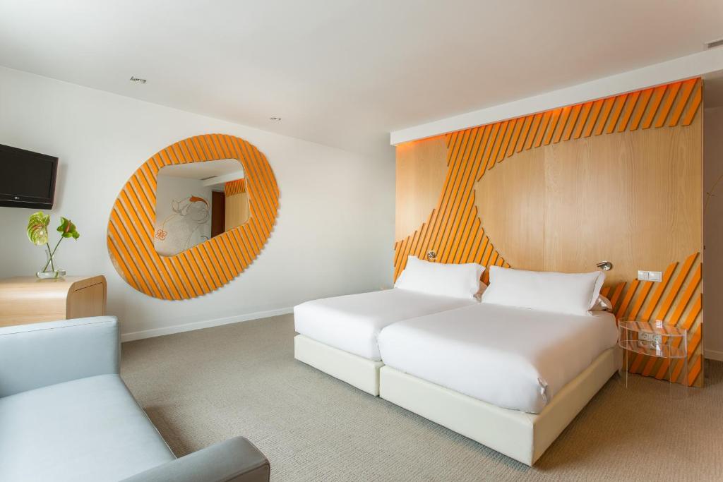 a bedroom with a white bed and a mirror at Room Mate Oscar, Madrid in Madrid