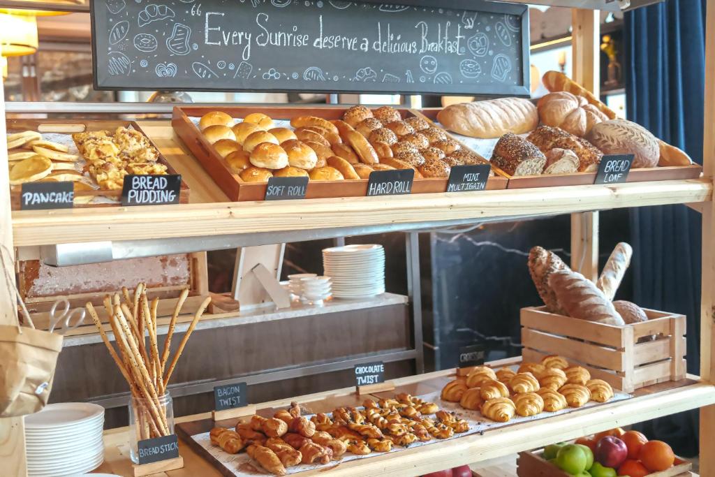 A bakery-style breakfast station filled with breads and pastries.