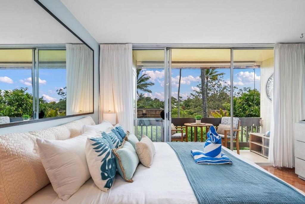 a bedroom with a large bed with blue and white pillows at Napili Ridge G16 · NR G16 Updated Napili Condo Walk to Napili Ba in Kahana