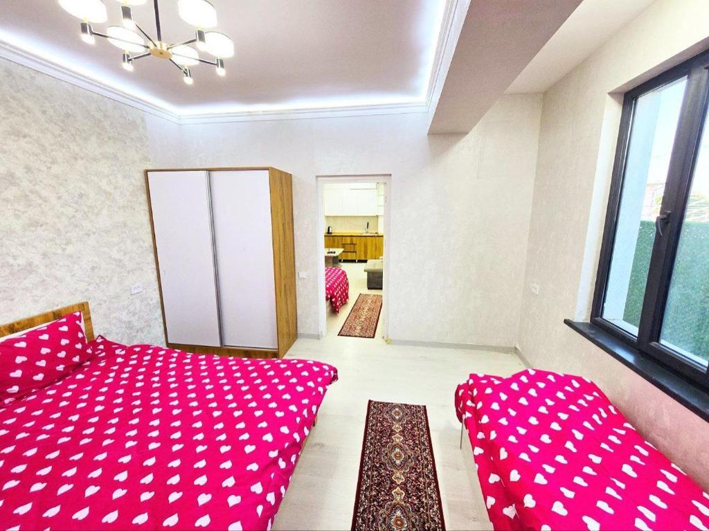 a living room with pink pillows and a couch at Comfortable Apartments in Tashkent