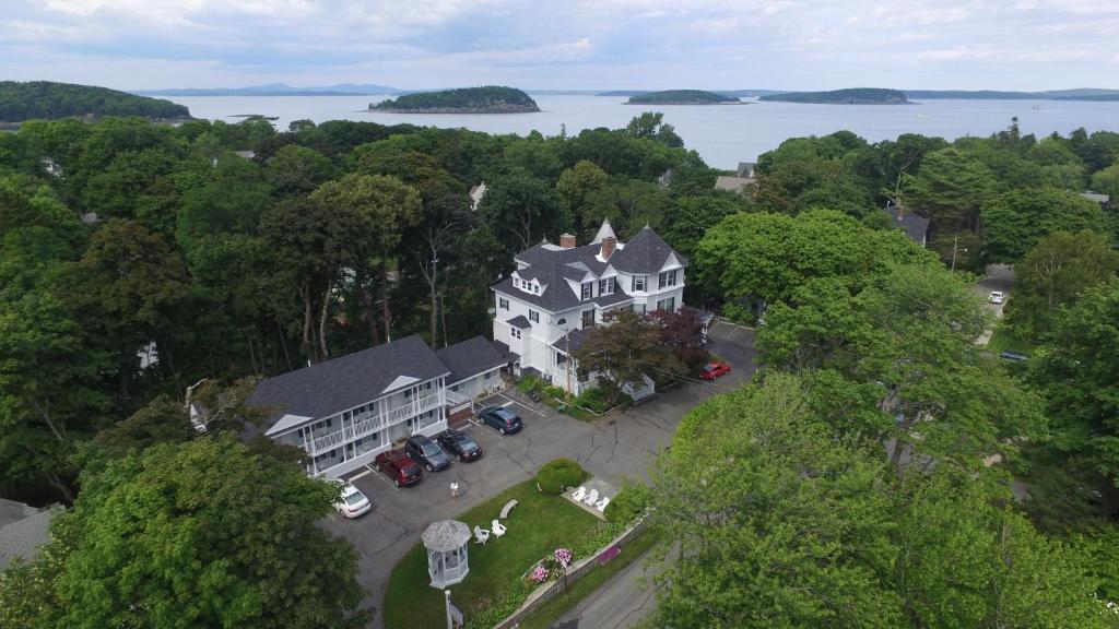 a large house with trees on top of it at Moseley Cottage Inn and The Town Motel in Bar Harbor
