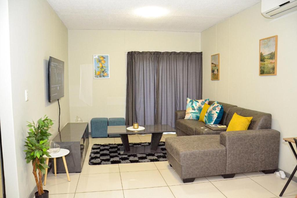 a living room with a couch and a table at Platinum Heights Merensky in Windhoek