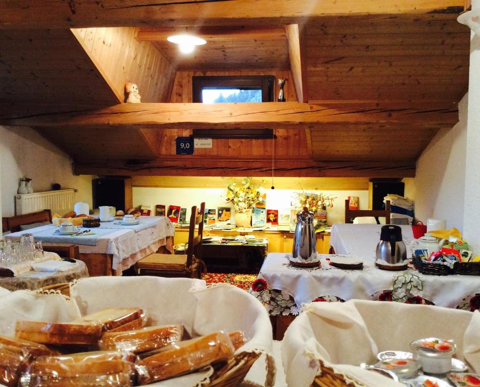 a room with two tables with white table cloths at B&B Sòl Fiorì in Agordo