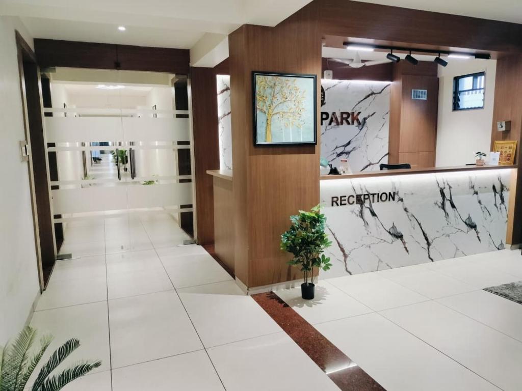a lobby with a park registration sign on the wall at Hotel Royal Park Rooms in Vapi