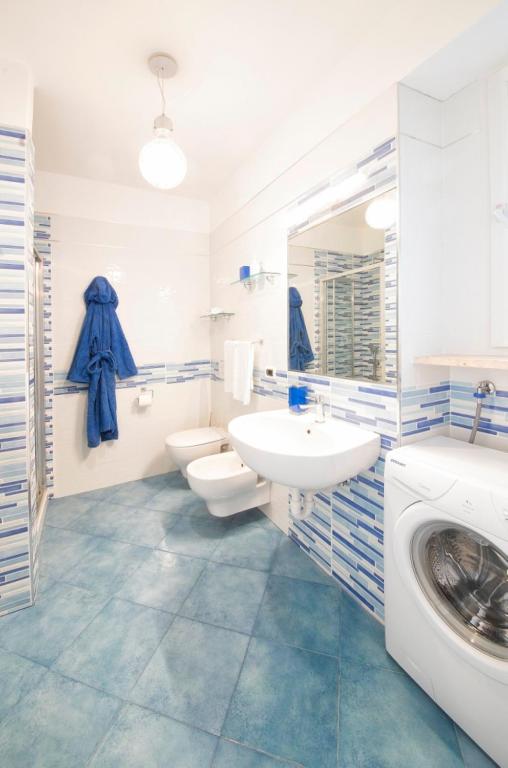 a bathroom with a sink and a washing machine at Casa Vacanze Parco Del Generale in Ischia