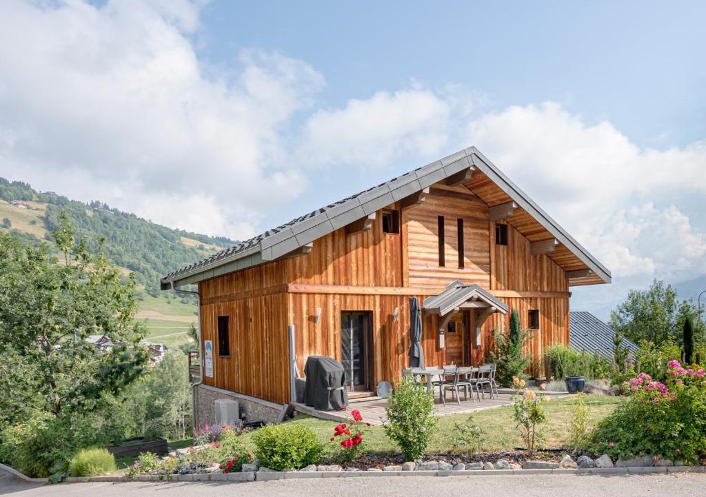 une maison en rondins avec un porche et un patio dans l'établissement Chalet Dolyo, à Le Fey