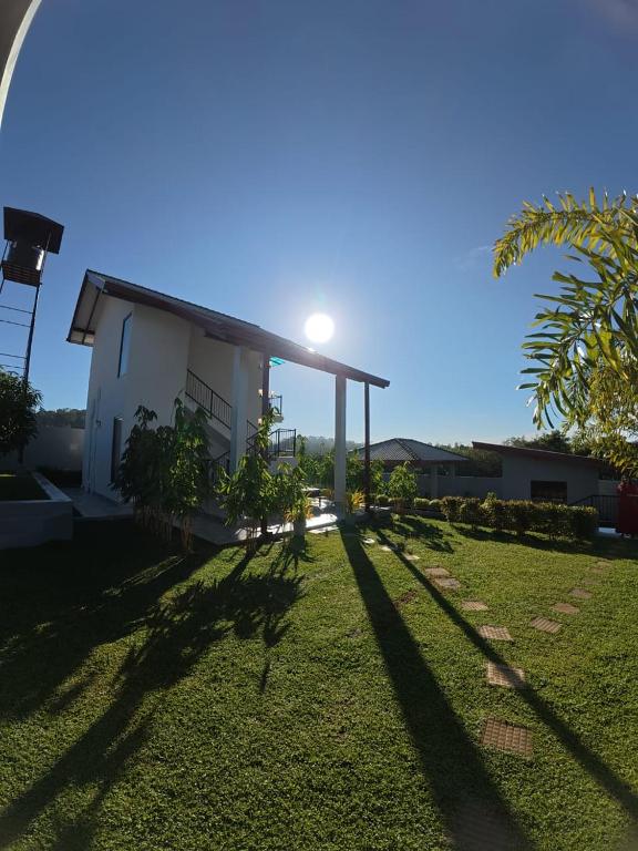 a view of a house with the sun behind it at Villa Barbara - Private Pool Villa in Ahungalla in Ahungalla