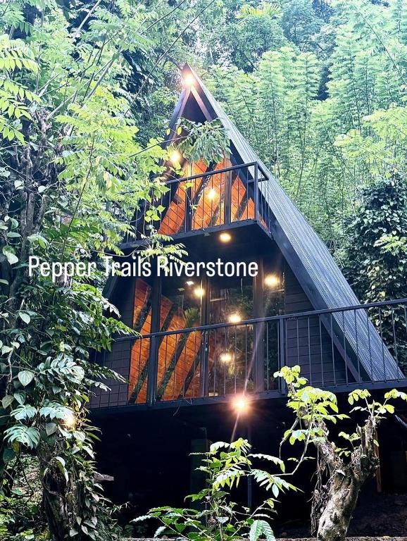 a tree house in the middle of a forest at Pepper Trails Riverstone in Polwattekanda