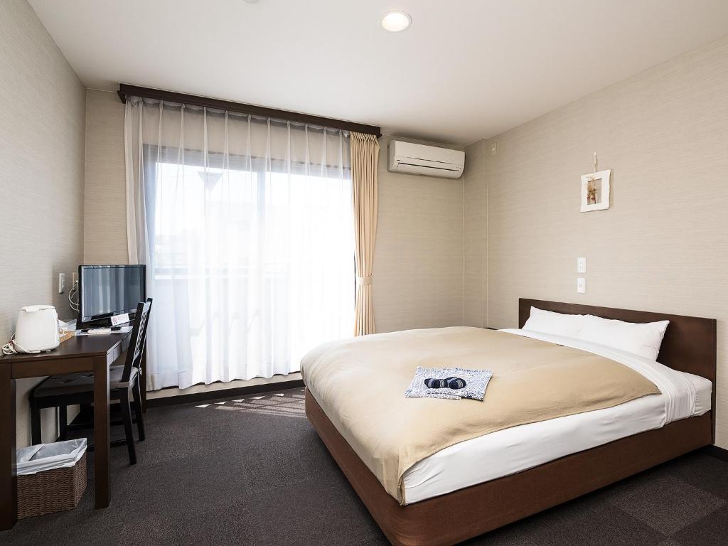 Posteľ alebo postele v izbe v ubytovaní Kusatsu onsen Futabaya