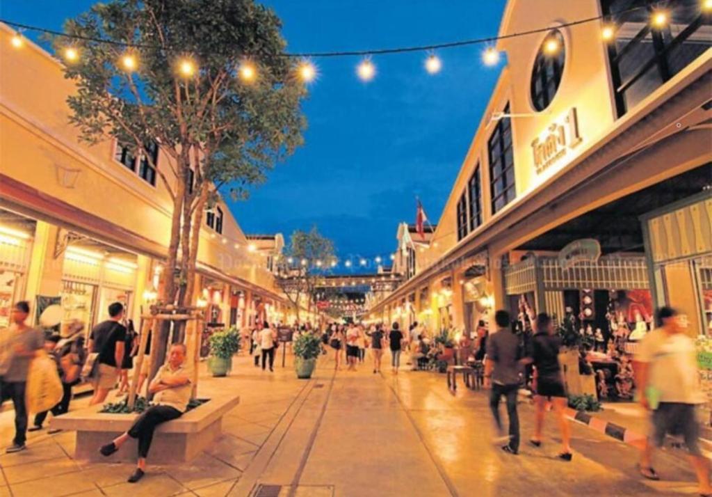a group of people walking through a shopping mall at SelfCheckIn TownHome in Charoen Nakhorn 60 near BTS Iconsiam Asiatique and Chaophraya River Maximum 4 Guests in Bangkok