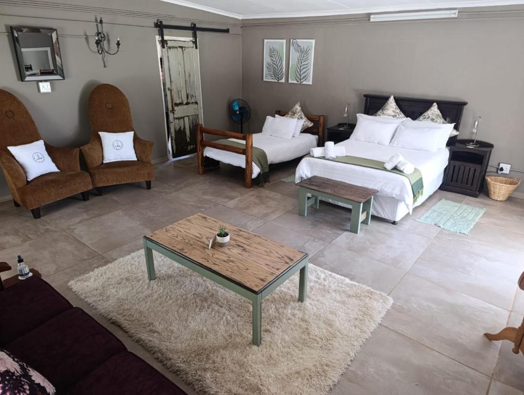 a living room with two beds and a coffee table at La Mouna 4 in Bultfontein in Bultfontein