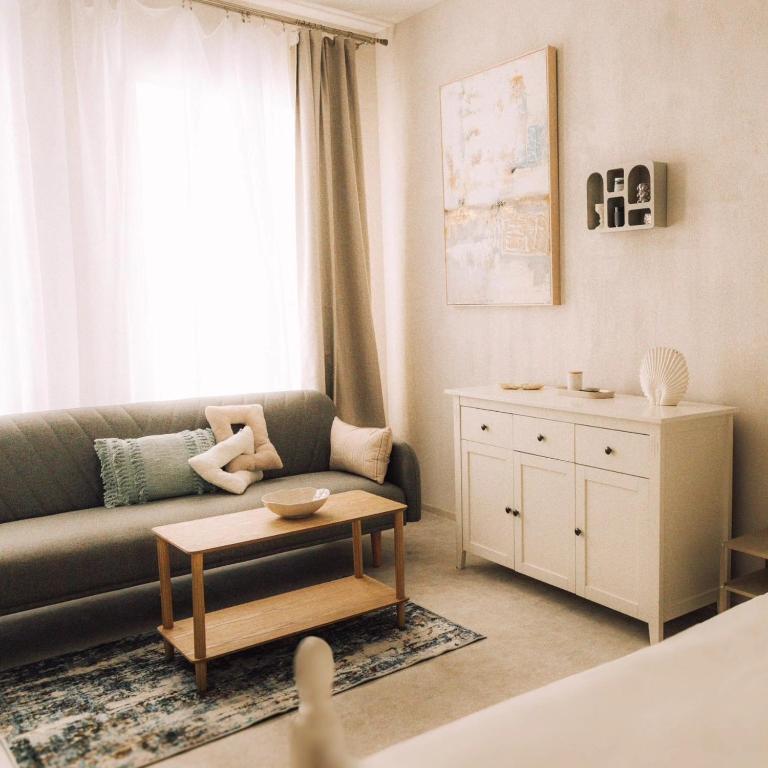 a living room with a couch and a table at Apartaments Nr 33 Viesu Nr 2 in Talsi