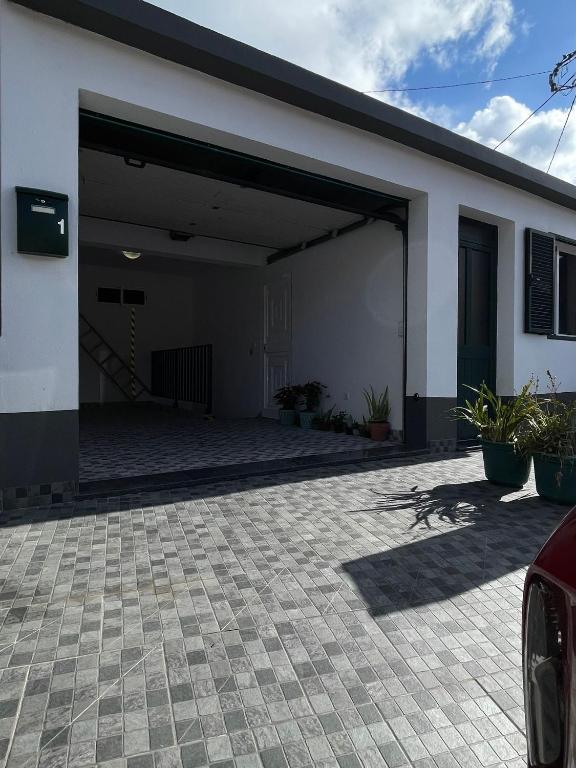 a garage with a door open on a house at Casinha da Montanha - Paraíso 7 in Ribeira Brava