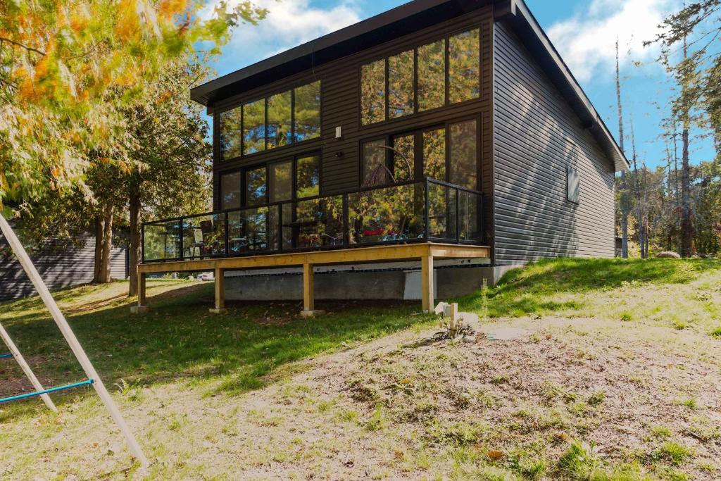a house with a large balcony on the side of it at 3-bedroom Lakefront Villa #3 in Lakefield