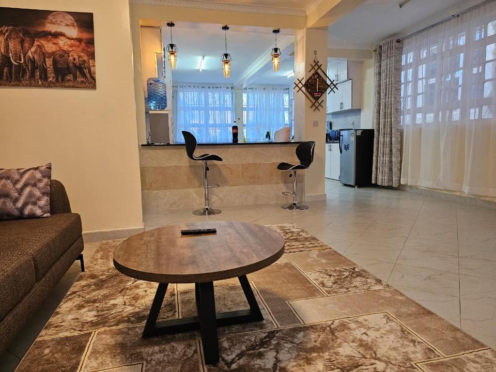 a living room with a couch and a coffee table at Pofu Stay Eldoret in Eldoret