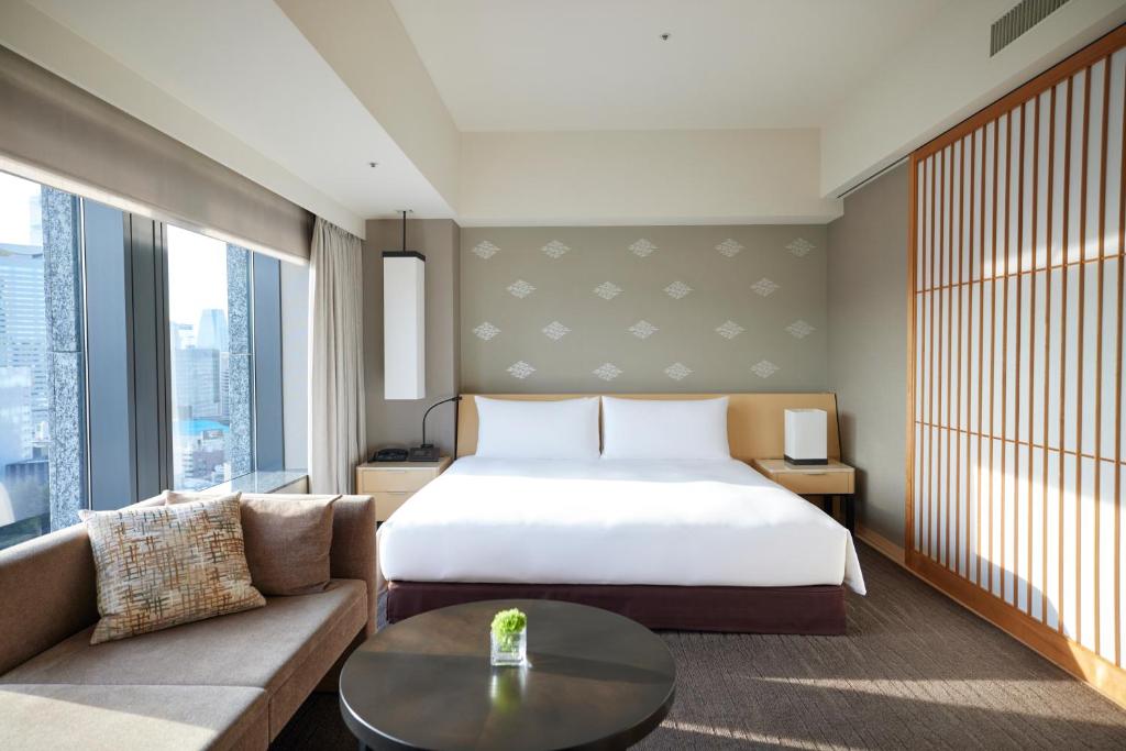 a hotel room with a bed and a couch at The Capitol Hotel Tokyu in Tokyo